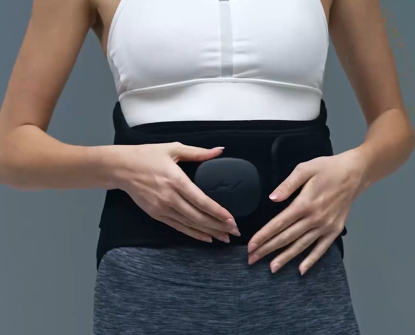 model wearing Venom 2 lower back heat and massager